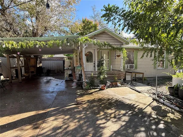 a patio with a table and chairs under an umbrella