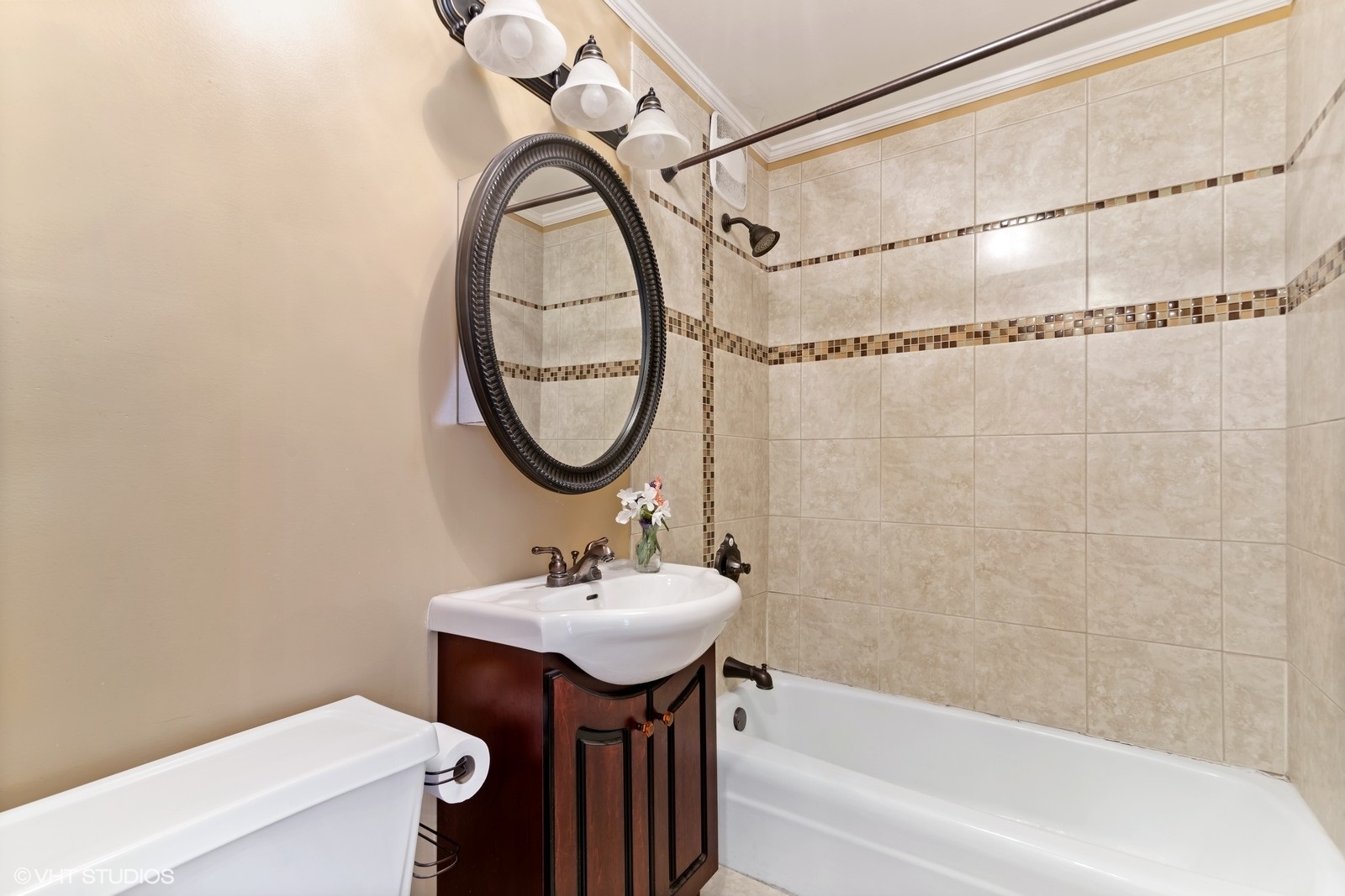 655 West Irving Park Road, Unit 1911 Chicago, IL 60613 - Photo 17 of 27 a bathroom with a sink and a mirror