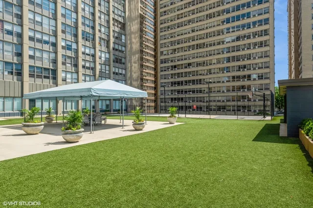 a view of a city with tall buildings and a big yard