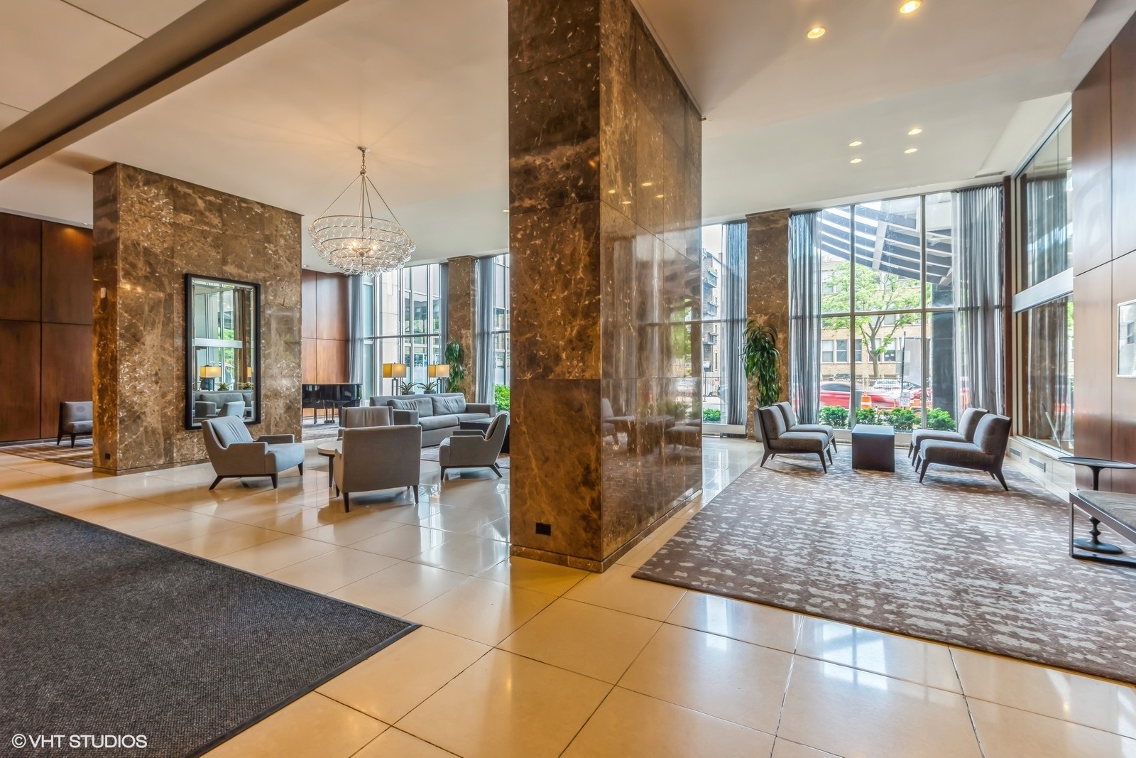 655 West Irving Park Road, Unit 1911 Chicago, IL 60613 - Photo 3 of 27 a lobby with furniture and floor to ceiling window