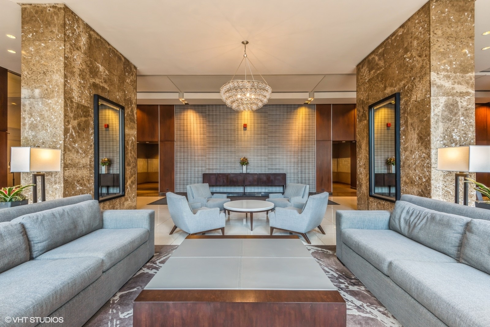 655 West Irving Park Road, Unit 1911 Chicago, IL 60613 - Photo 4 of 27 a living room with furniture chandelier and a large window