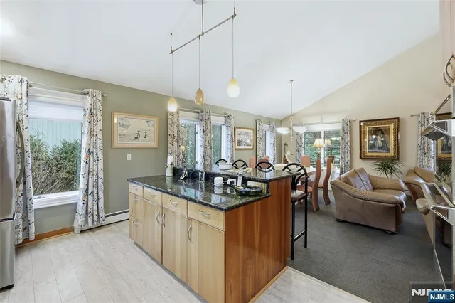 a kitchen with counter top space and living room