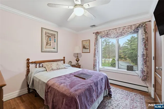 a bedroom with a large bed and a large window