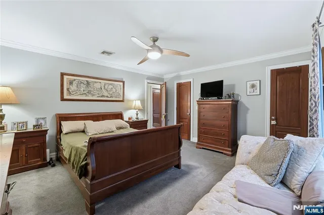 a bed room with a bed and a television