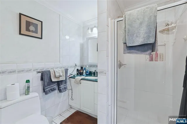 a bathroom with a bathtub sink mirror and toilet