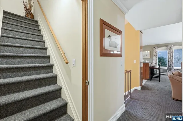 a view of a hallway with wooden floor and entryway