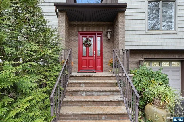 a front view of a house with potted plants