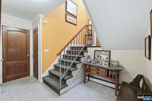 a living room with stairs and a wooden floor