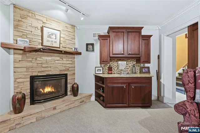 a room with fireplace and wooden cabinets