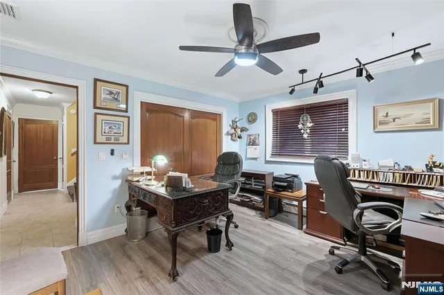 a view of a workspace with furniture and a window