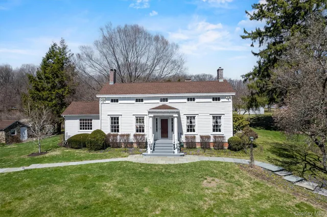 a view of a house with a backyard porch and sitting area