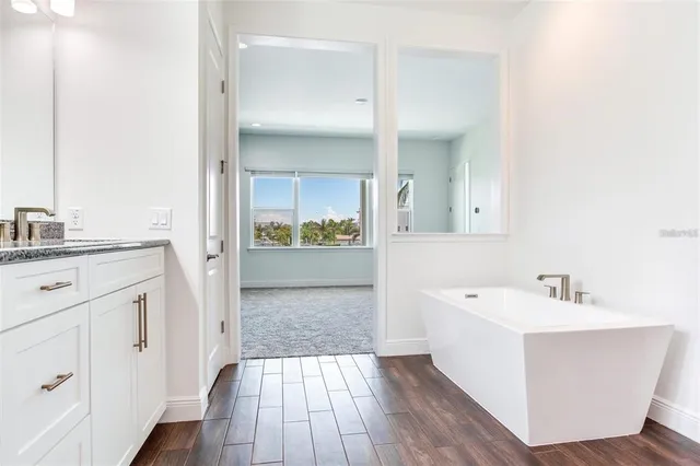 a bathroom with a sink a mirror and a bathtub