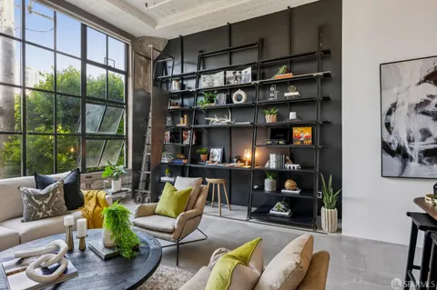 a living room with furniture a lamp and a window