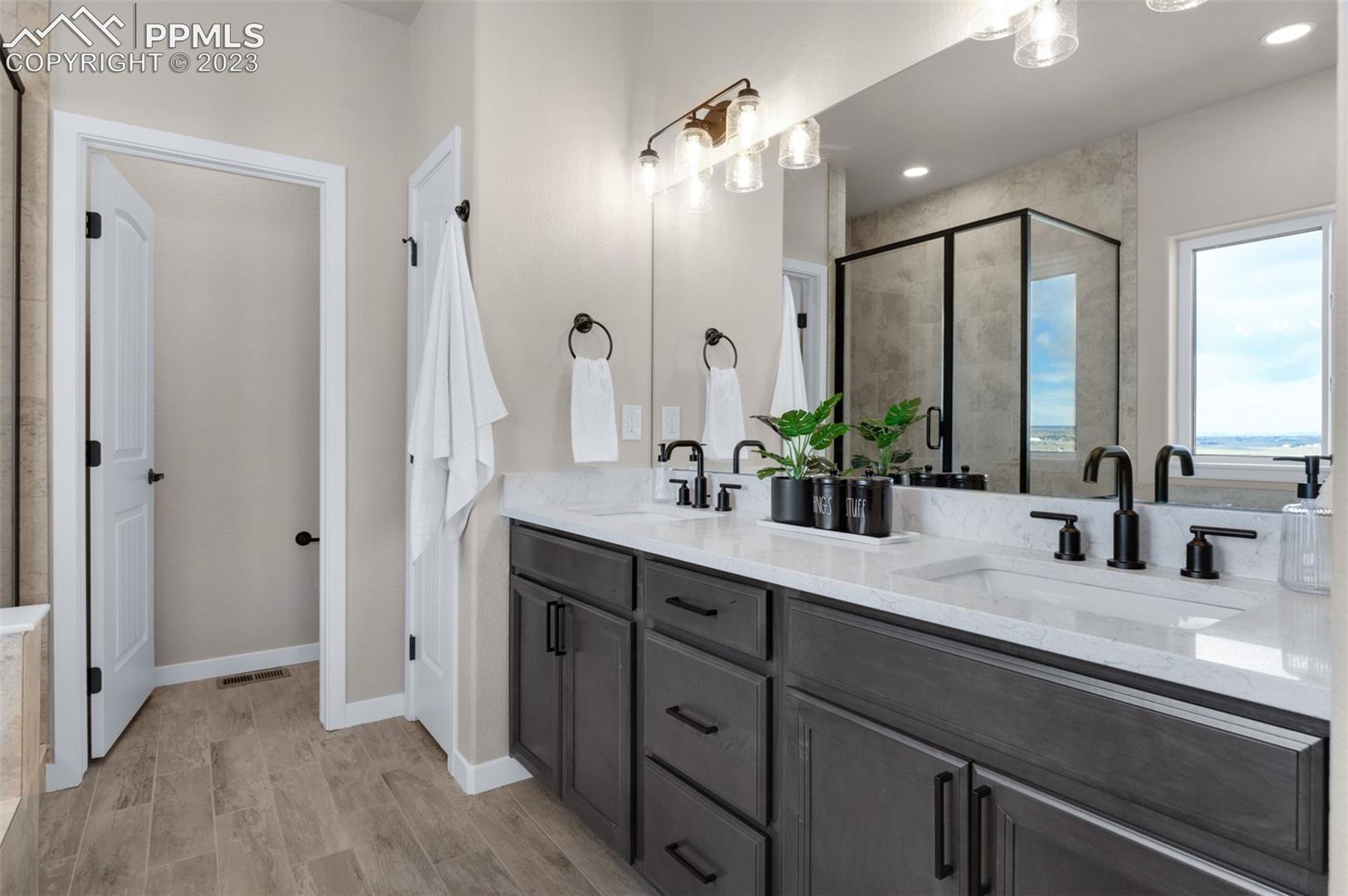2970 Hoofprint Road Peyton, CO 80831 - Photo 27 of 42 Master Bath Double Sinks With Solid Surface Tops, Rubbed Oil Bronze Fixtures & Under Mount Sinks