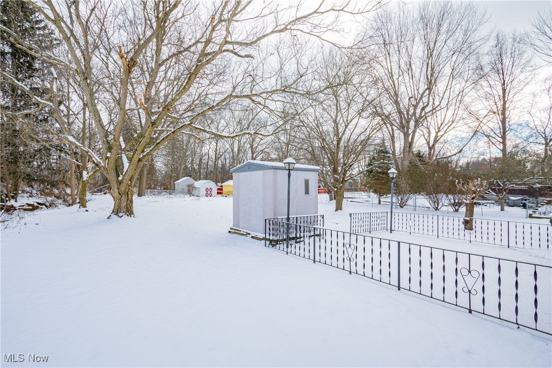 5905 Renninger Road New Franklin, OH 44319 - Photo 25 of 31 Yard layered in snow with a storage unit