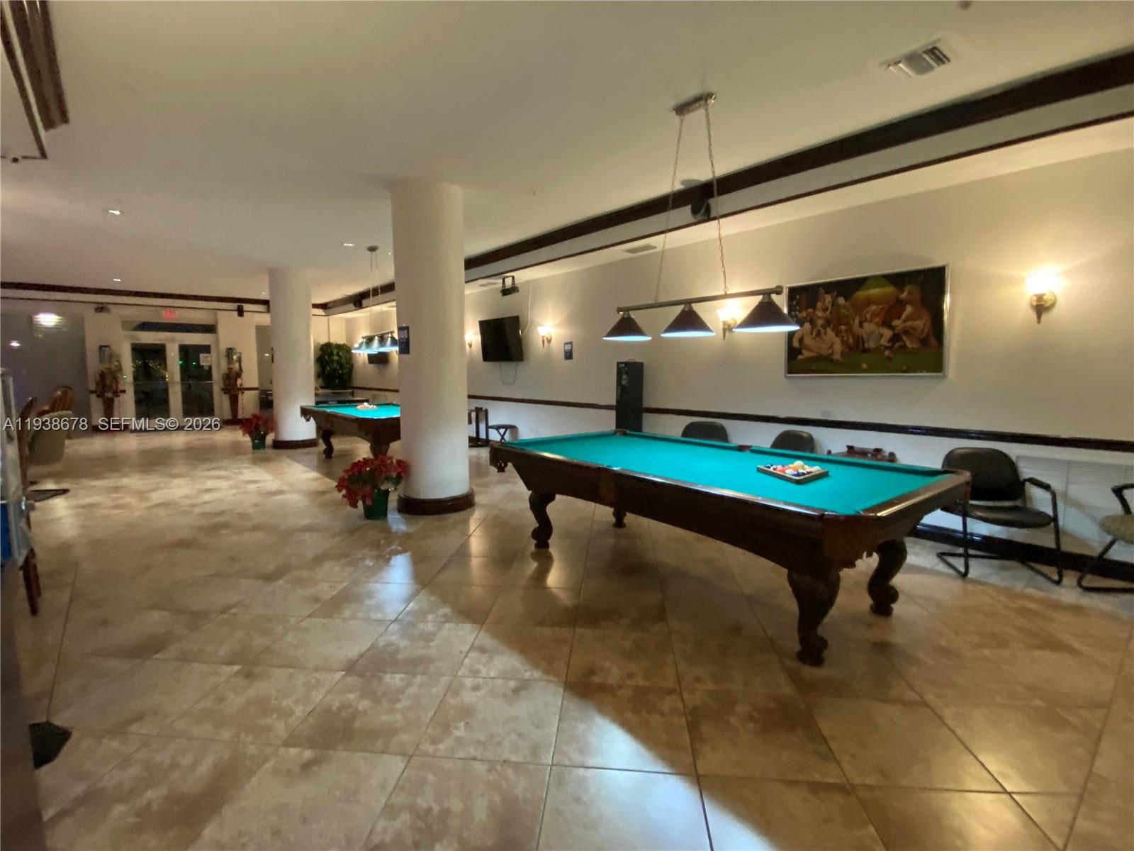 5091 Northwest 7th Street, Unit 1015 Miami, FL 33126 - Photo 16 of 30 a living room with furniture pool table and a table