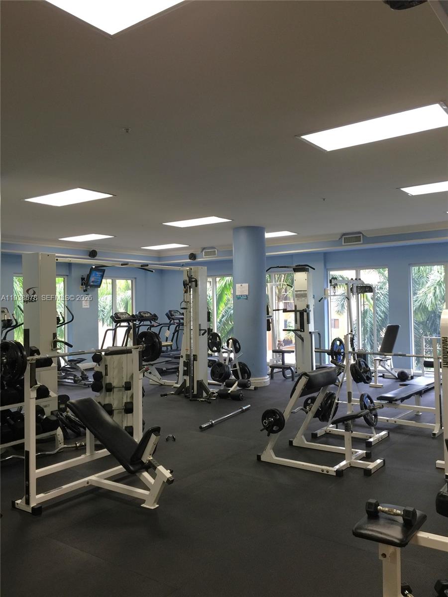 5091 Northwest 7th Street, Unit 1015 Miami, FL 33126 - Photo 17 of 30 a view of a room with gym equipment