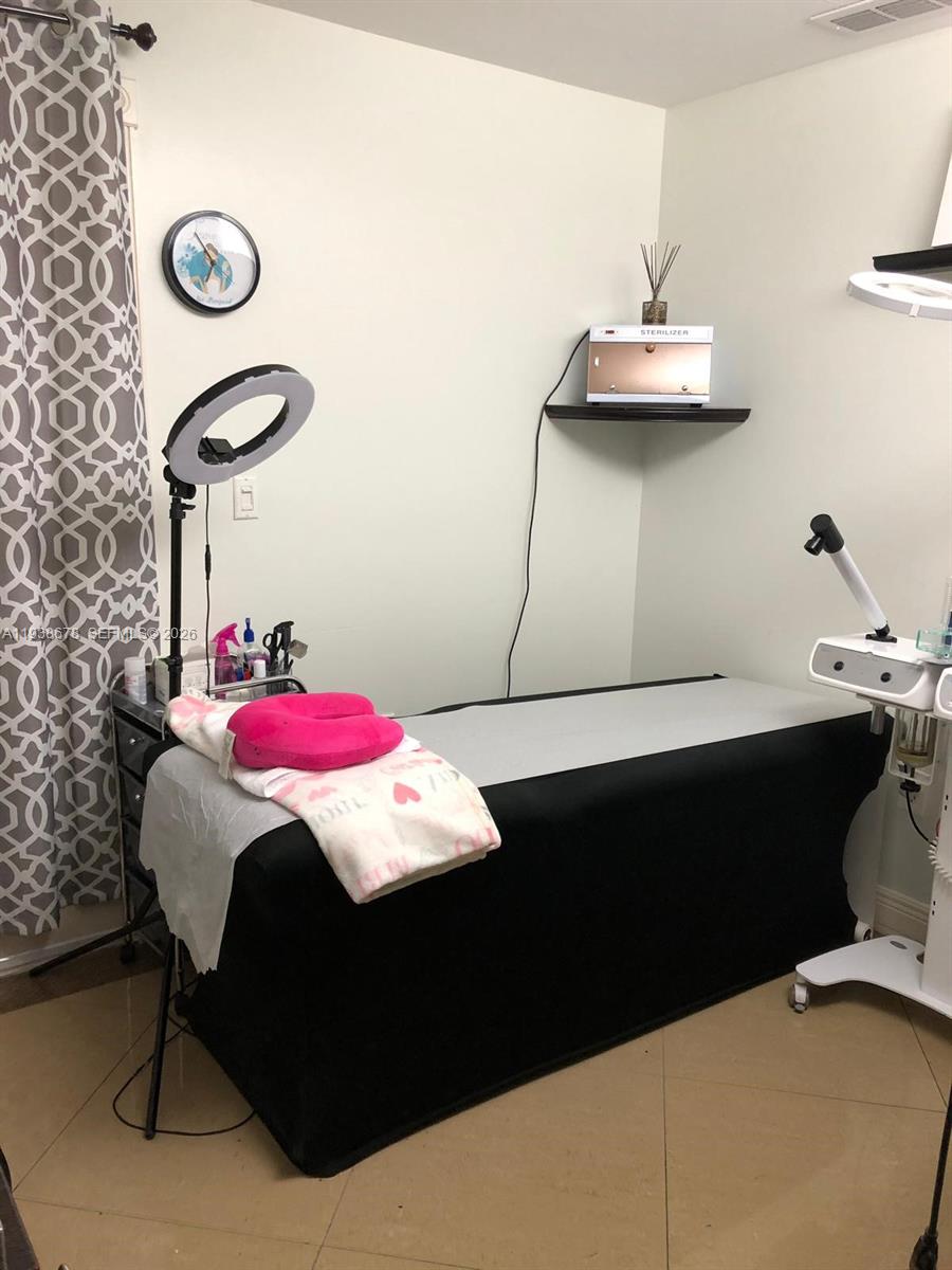 5091 Northwest 7th Street, Unit 1015 Miami, FL 33126 - Photo 19 of 30 a room with a table chairs and a chandelier