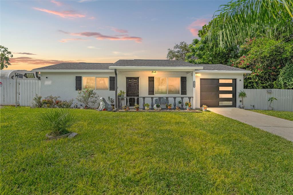 a front view of house with yard and green space