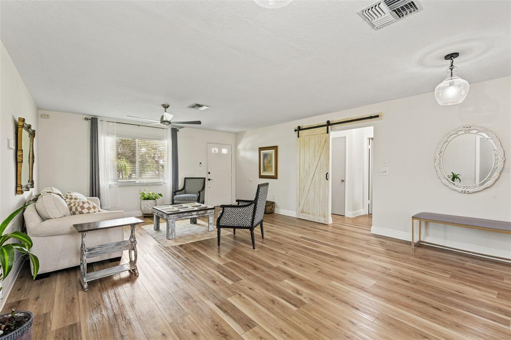 11487 Linden Drive Spring Hill, FL 34608 - Photo 14 of 42 a living room with furniture a wooden floor and a large window