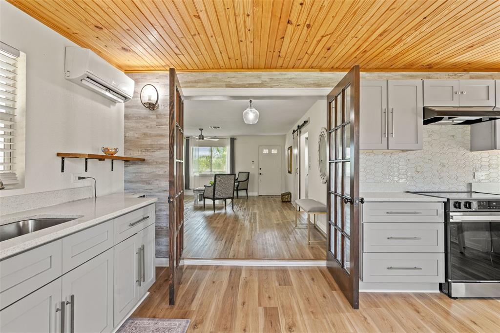 11487 Linden Drive Spring Hill, FL 34608 - Photo 18 of 42 a kitchen with wooden floor and white appliances