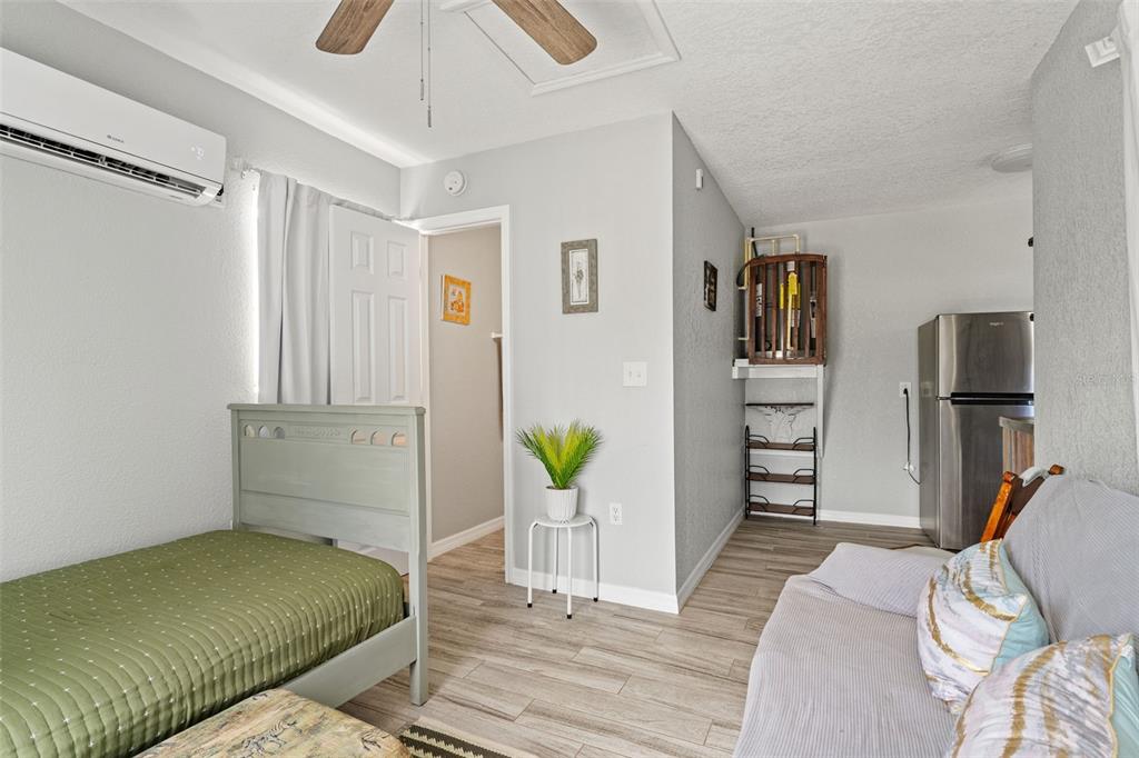 11487 Linden Drive Spring Hill, FL 34608 - Photo 32 of 42 a bedroom with a bed and a view of living room