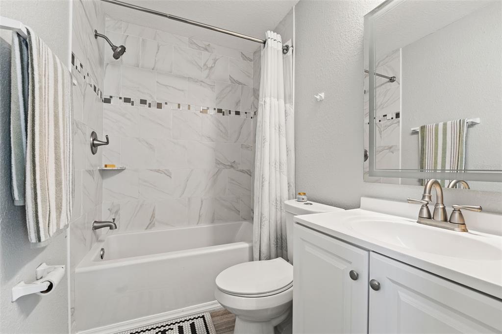 11487 Linden Drive Spring Hill, FL 34608 - Photo 33 of 42 a bathroom with a sink toilet and shower