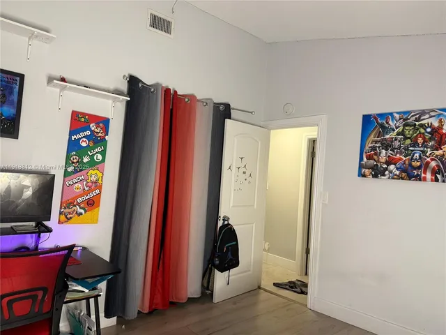 a view of a room with wooden floor and stairs