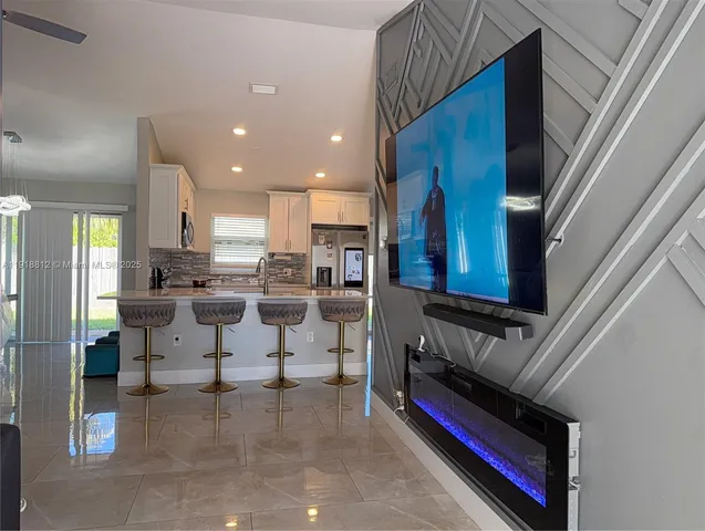 a kitchen with stainless steel appliances kitchen island granite countertop a refrigerator and a stove
