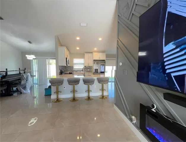 a living room with lots of furniture and a view of living room