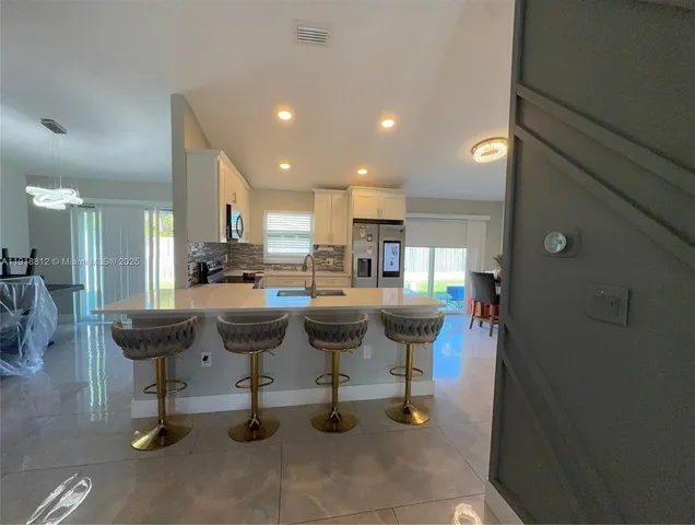 a kitchen with a table and chairs