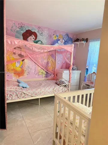 a view of a balcony with furniture and floor to ceiling window