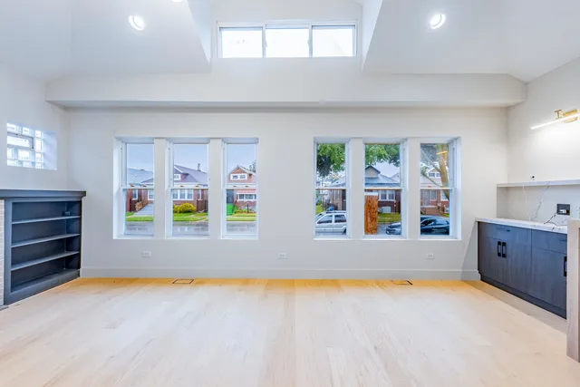 a kitchen with stainless steel appliances granite countertop a stove a sink and white cabinets