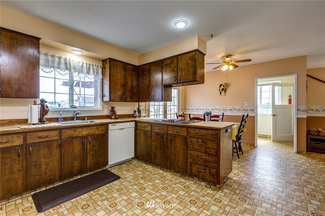 401 West Pole Road Lynden, WA 98264 - Photo 11 of 40 a kitchen with stainless steel appliances kitchen island granite countertop a sink and cabinets