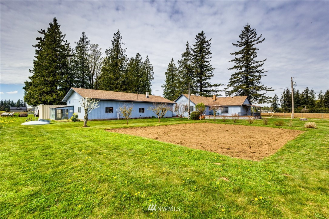 401 West Pole Road Lynden, WA 98264 - Photo 3 of 40 a house view with swimming pool and trees in the background