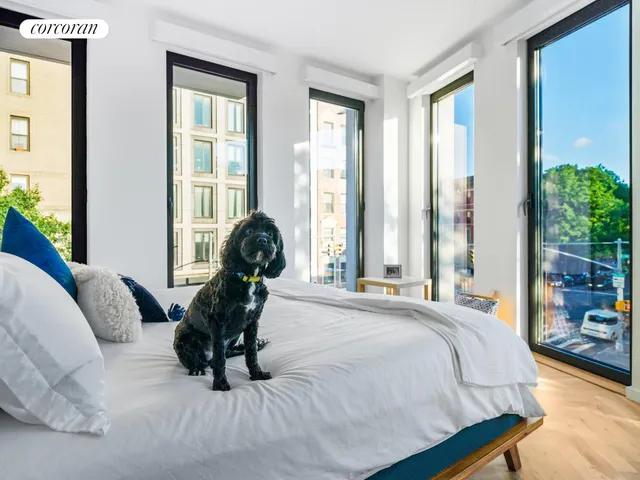 a bedroom with a bed and a large window
