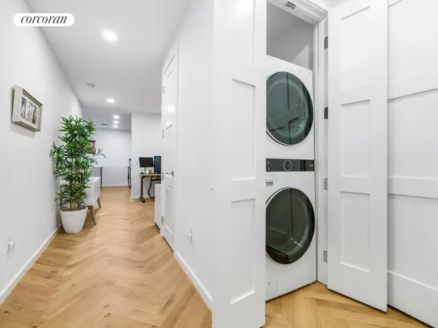 a view of a hallway with washer and dryer