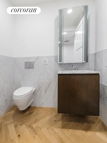 a bathroom with a sink a toilet and mirror