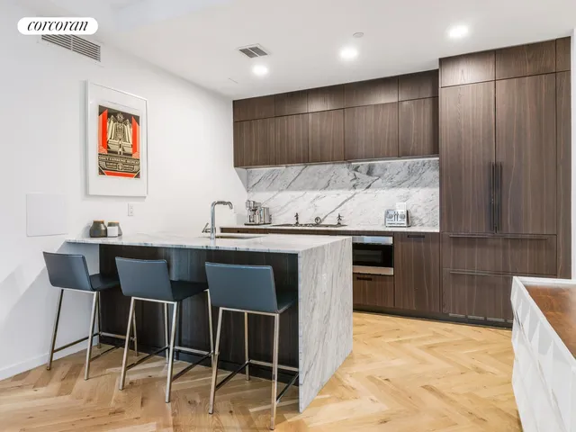 a kitchen with stainless steel appliances kitchen island granite countertop a sink and cabinets