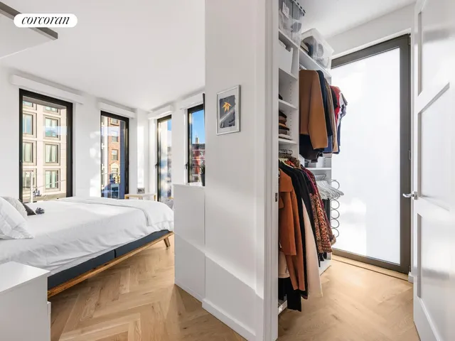 a spacious bedroom with a large bed and a window