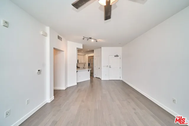 a view of a kitchen with a sink and wooden floor