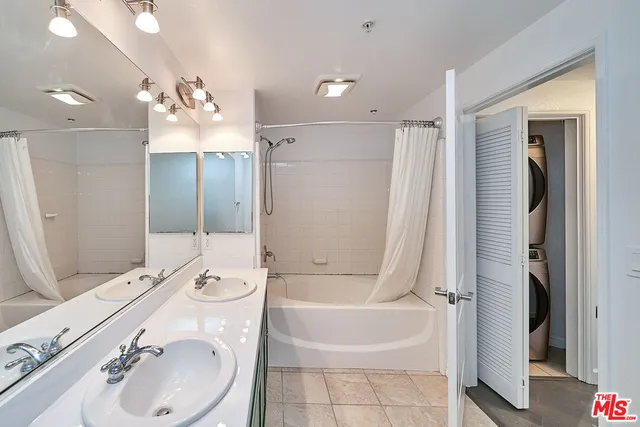 a bathroom with a bathtub shower sink vanity granite and toilet