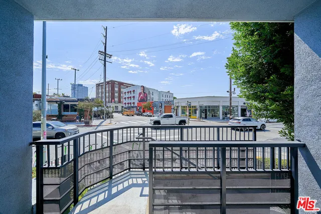 a balcony with wooden floor and potted plants