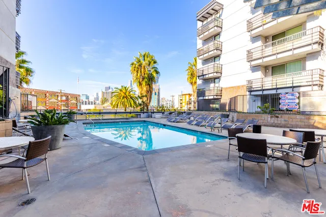a living room with lots of furniture and a floor to ceiling window