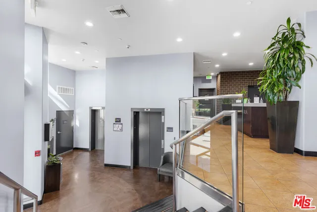 a view of entryway with furniture and windows