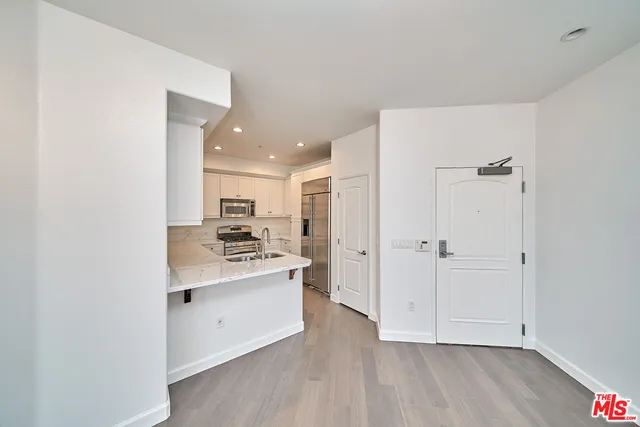 a kitchen with stainless steel appliances granite countertop a stove and a refrigerator