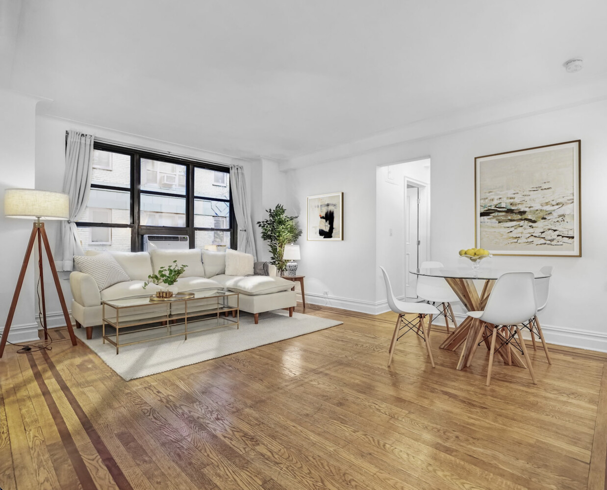 235 East 22nd Street, Unit 2T Manhattan, NY 10010 - Photo 1 of 12 a living room with furniture and a large window