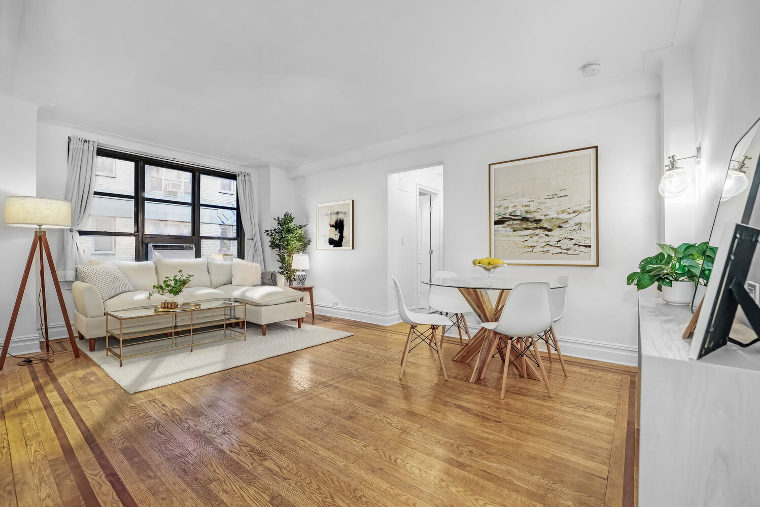 235 East 22nd Street, Unit 2T Manhattan, NY 10010 - Photo 4 of 12 a living room with furniture and a table