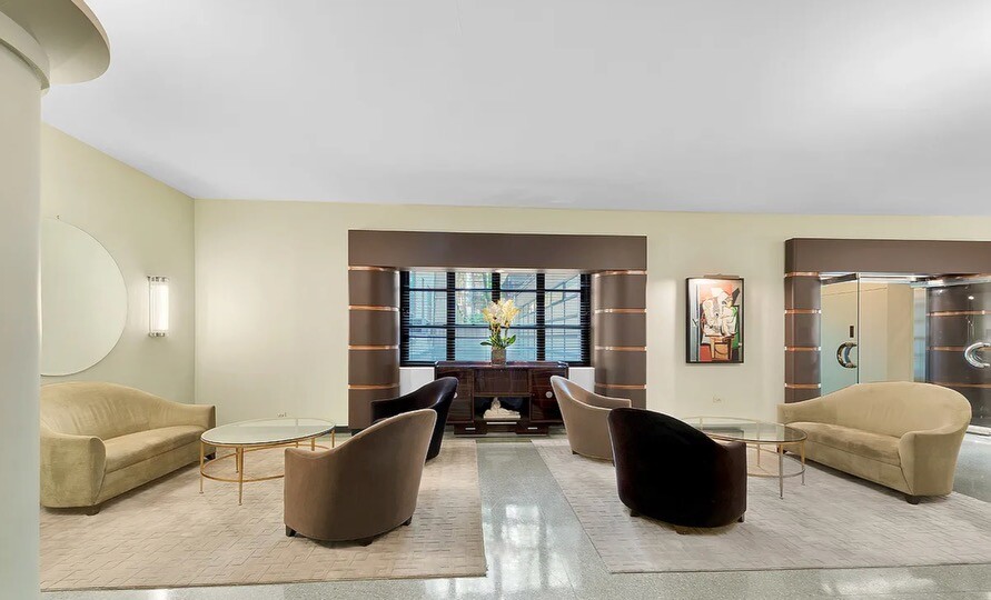 235 East 22nd Street, Unit 2T Manhattan, NY 10010 - Photo 7 of 12 a living room with furniture and a large window
