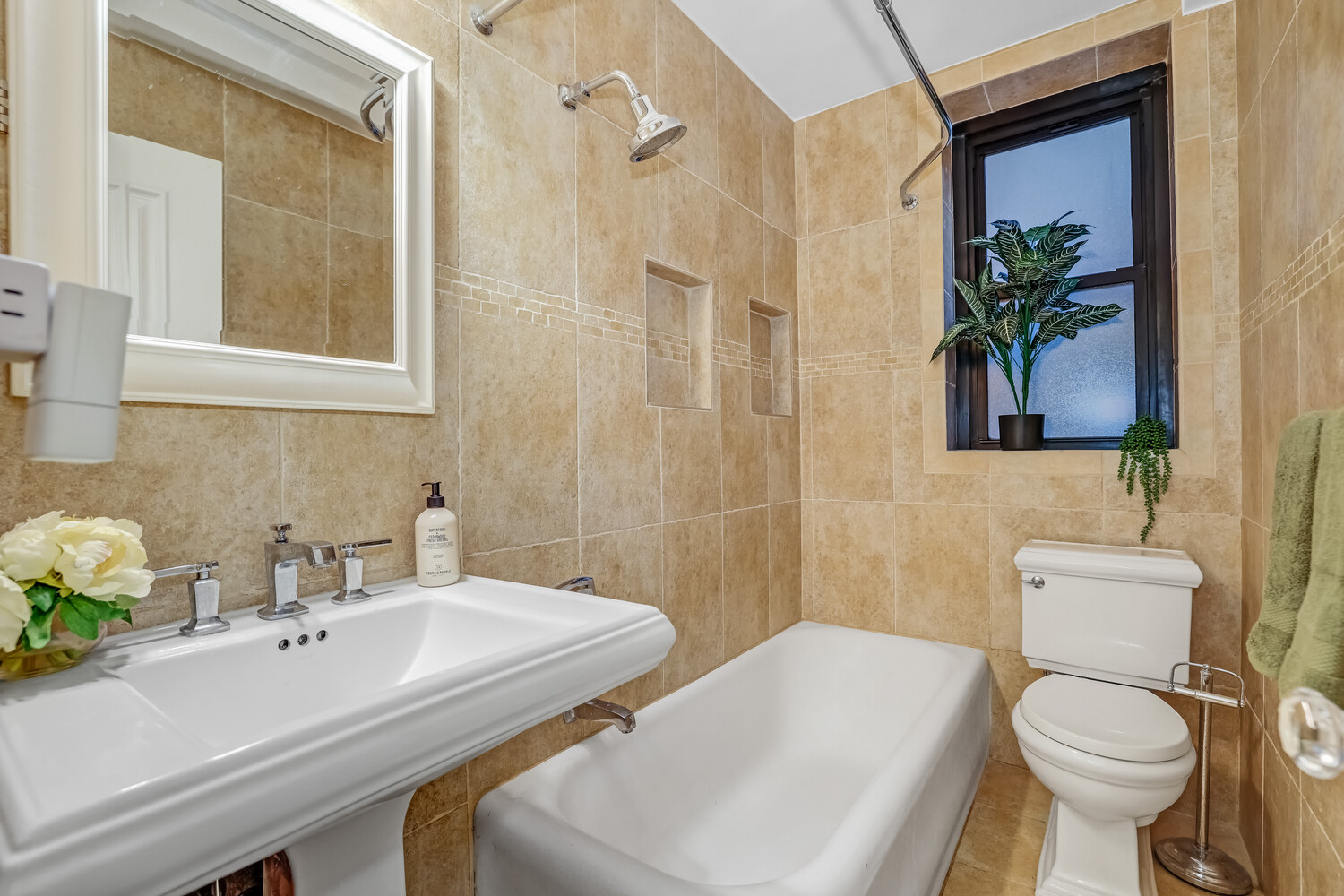 235 East 22nd Street, Unit 2T Manhattan, NY 10010 - Photo 9 of 12 a bathroom with a sink toilet and shower